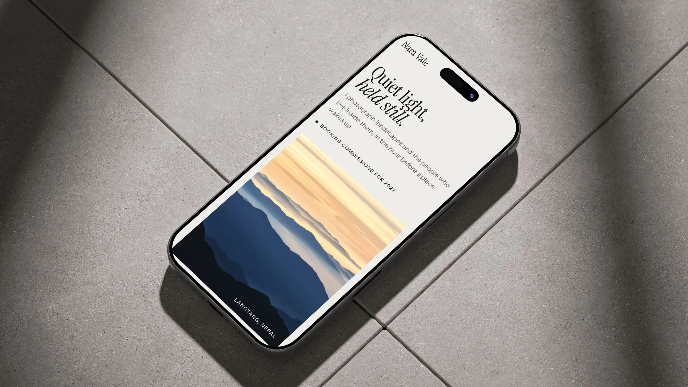Nara Vale homepage on an iPhone lying on sunlit floor tiles
